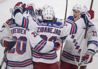 New York Rangers' Chris Kreider (20) celebrates with teammates after scoring against the Montreal Canadiens during the second period of an NHL hockey game Saturday, Oct. 16, 2021, in Montreal. (Graham Hughes/The Canadian Press via AP)